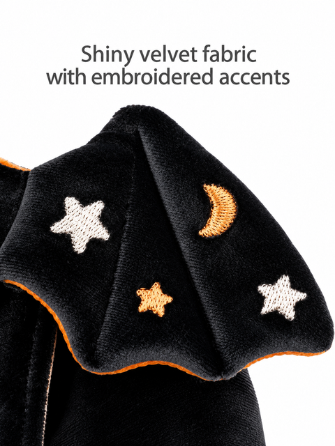 Close-up of the soft black velvet fabric with embroidered stars and crescent moon details.